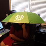 Sitting in her office, Sonja Williams the CEO of ShockTheory protects herself from the sunshine in the office.